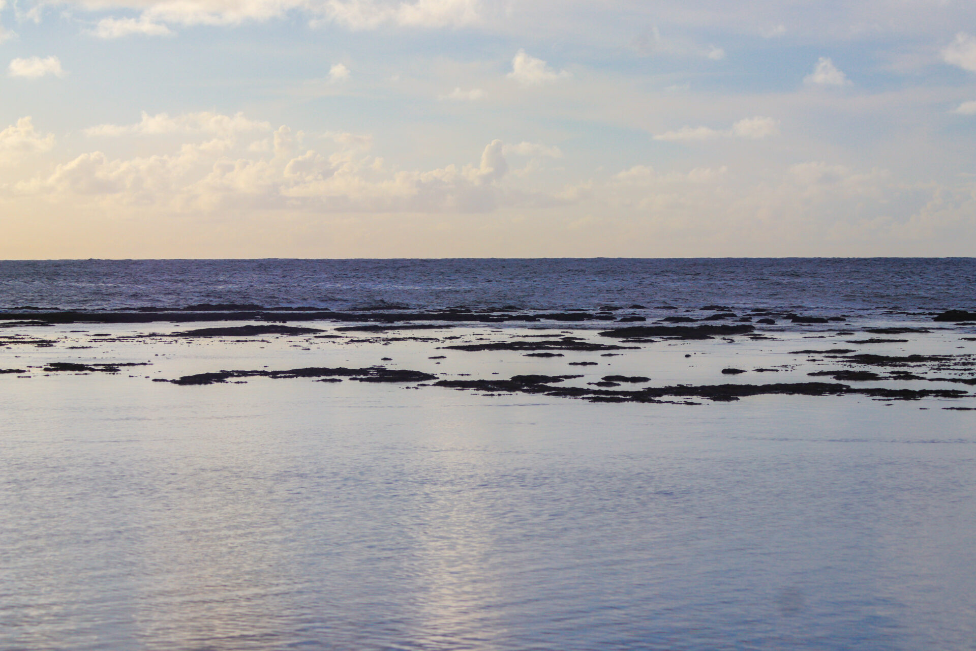 Ke'e Beach in Kaua'i with the sun starting to set and the skies are starting to become more golden